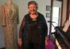 Our Glad Association president Leonie Egan with a dress worn by Gladys Moncrieff.