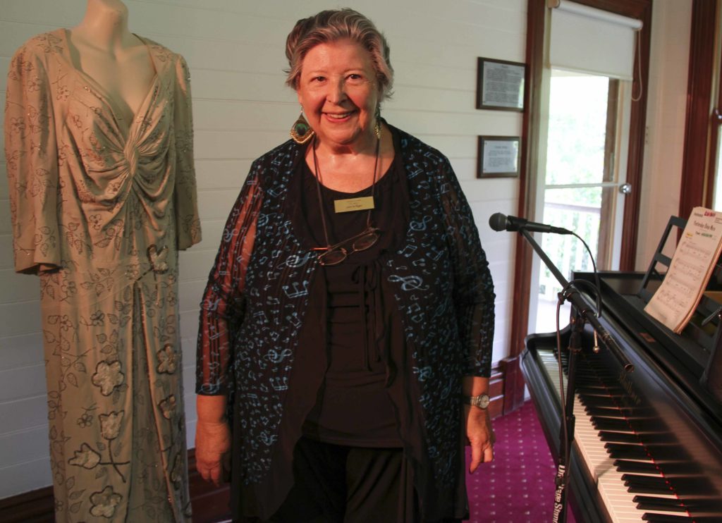 Our Glad Association president Leonie Egan with a dress worn by Gladys Moncrieff.