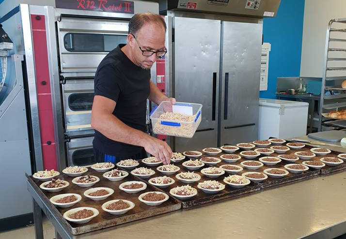 Brett Clark with some of his creations at Moore Park Beach Bakery, Busy B'z Bakery.