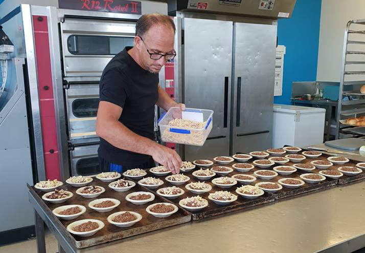 Brett Clark with some of his creations at Busy B'z Bakery, Moore Park Beach.