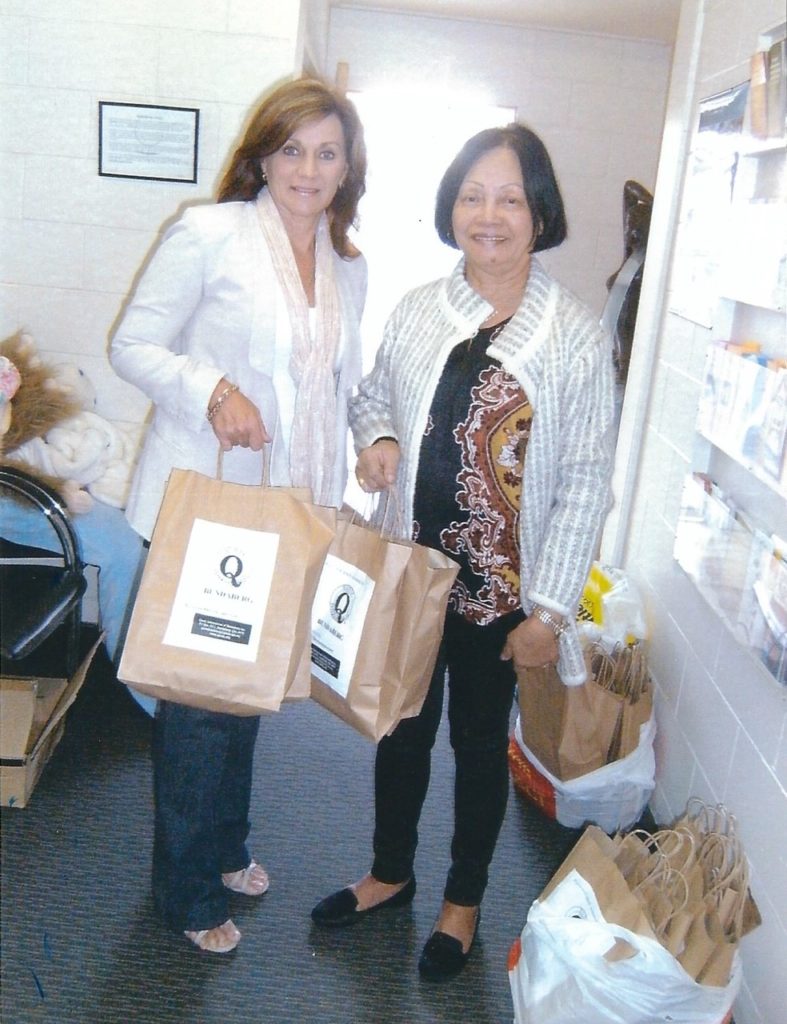 Lyne Booth of Edon Place accepting Personal Care Packs from Quotarian  Dympna Kimmorley.