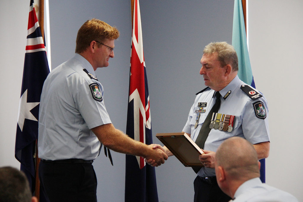 Bundaberg Police awards: Senior Sergeant Glenn Cameron receives and award from Assistant Commissioner Clem O’Regan.