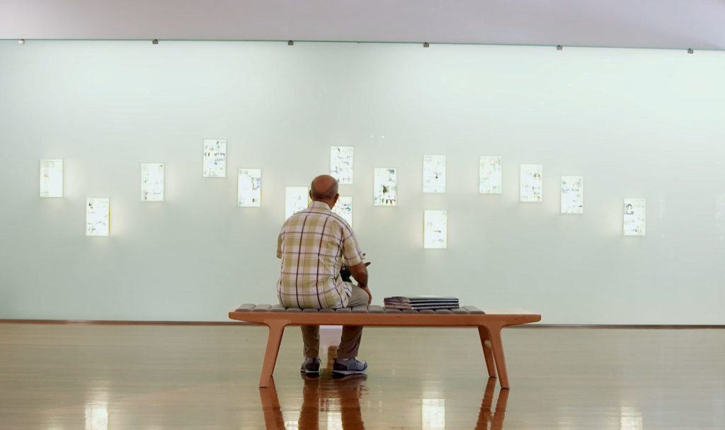 Artist Sam Di Mauro sits at Childers Arts Space looking at the Childers Backpacker Hostel Memorial.