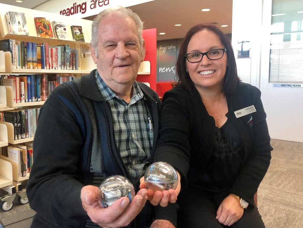 President of Friends of the Library Bob Adam and Bundaberg Library manager Peta Browne with some Sphero robots.