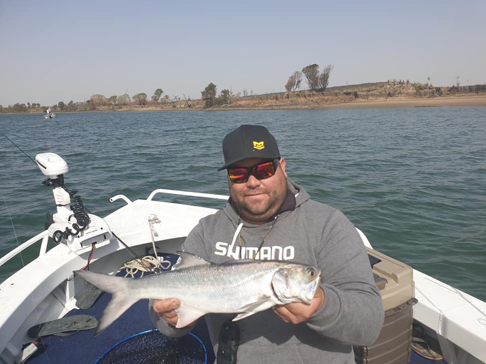 Adam Turner with a  blue salmon caught in the Burnett River. 