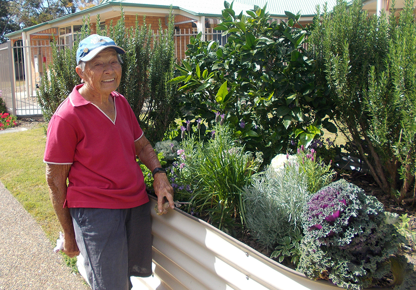 Carinity Volunteer of the Year Del Baxter at Kepnock Grove's herb garden