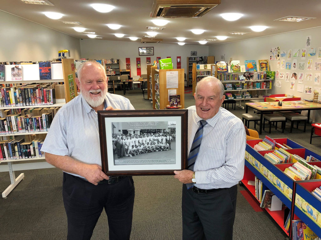 Alf Bonanno presents Deputy Mayor Cr ill Trevor with a framed photograph of Childers runners who participated in the 1956 Olympic Games torch relay.