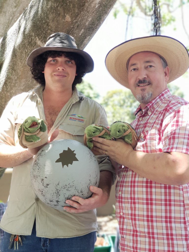 Three of the baby turtle mascots with Zane from the Alexandra Park Zoo and David from Dad's Read.