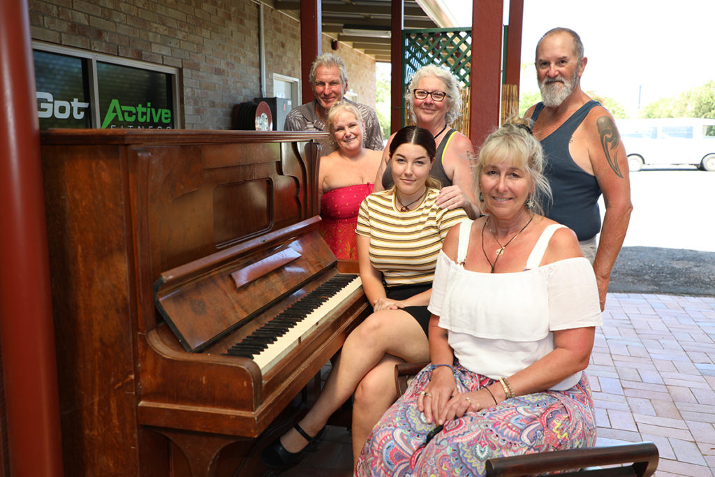 Phillip O'Neill, Donna O'Neill, Lynne Giles, Mark Giles, Shay Jackson and Sharon Jackson take turns on the piano.