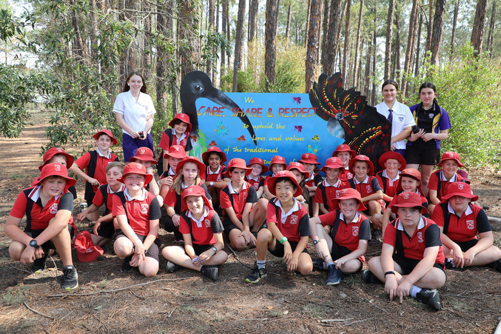 Gooburrum State School and Bundaberg North State High School students in front of the new forestry sign.