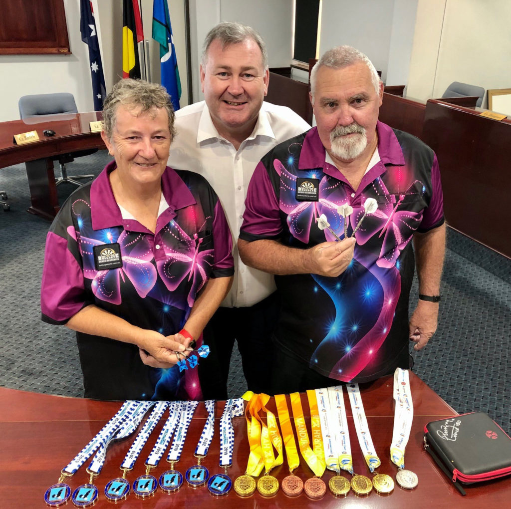 Bullseye! Mayor Jack Dempsey congratulates Gin Gin SES couple Nygerie Molloy and Bob Barkle on their swag of medals won at various emergency services games.