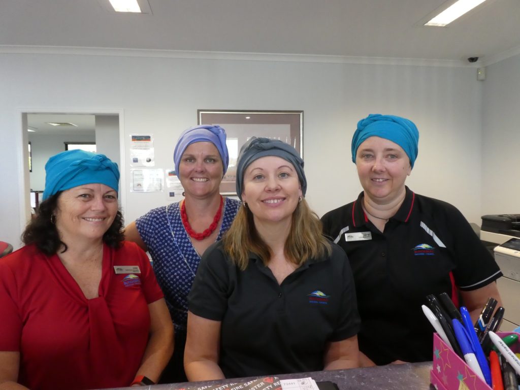 Chemotherapy turbans worn by Gin Gin Neighbourhood Centre's Amber Larsen, Lee-Anne Tober, Venessa Van Peype and Louise Gostelow.