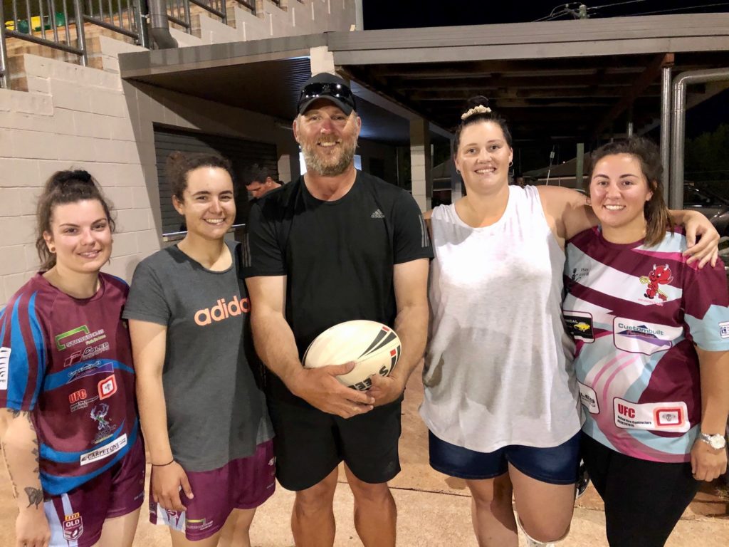 Isis Women's Coach Greg Royan with some of his players