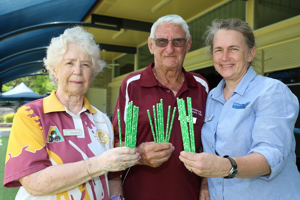 Bundaberg Bowls Club members Marcia Nicol, John Clough and Burnett LMAC Chair Sue SargentSue Sargent with the #LessIsMore paper straws.