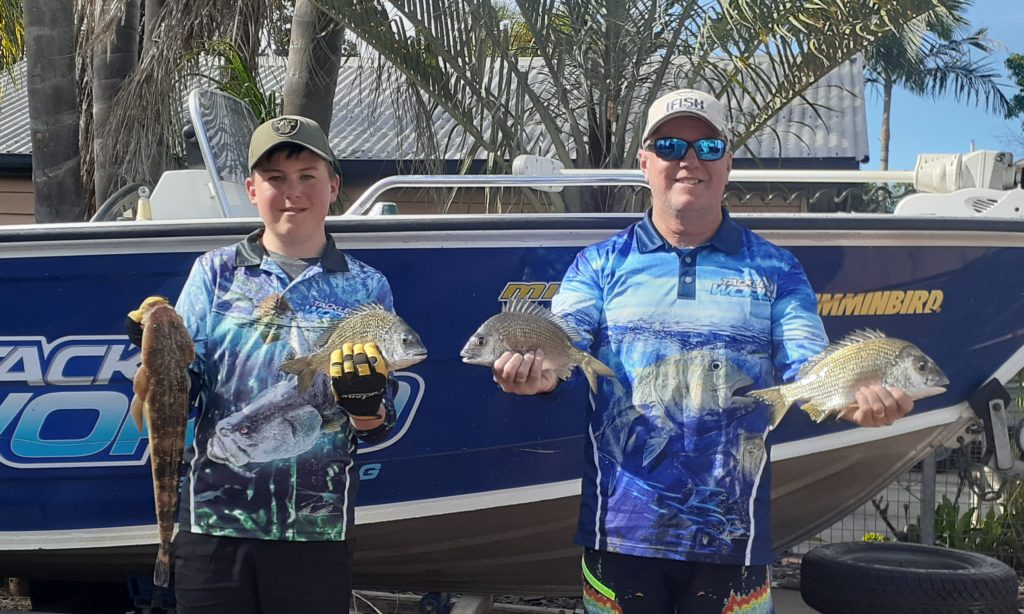 Shane Anderson and his son Ashton with the flathead and bream they caught recently.