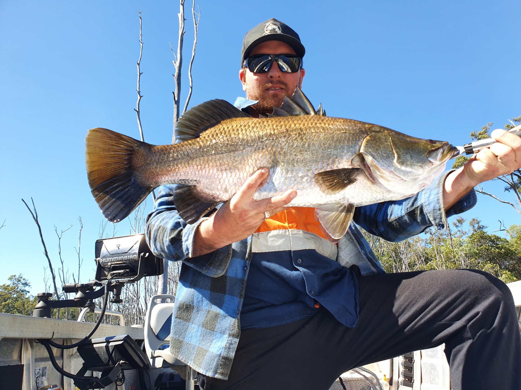 Nathan Sutton with the 75cm barramundi he caught at Lake Monduran this week.