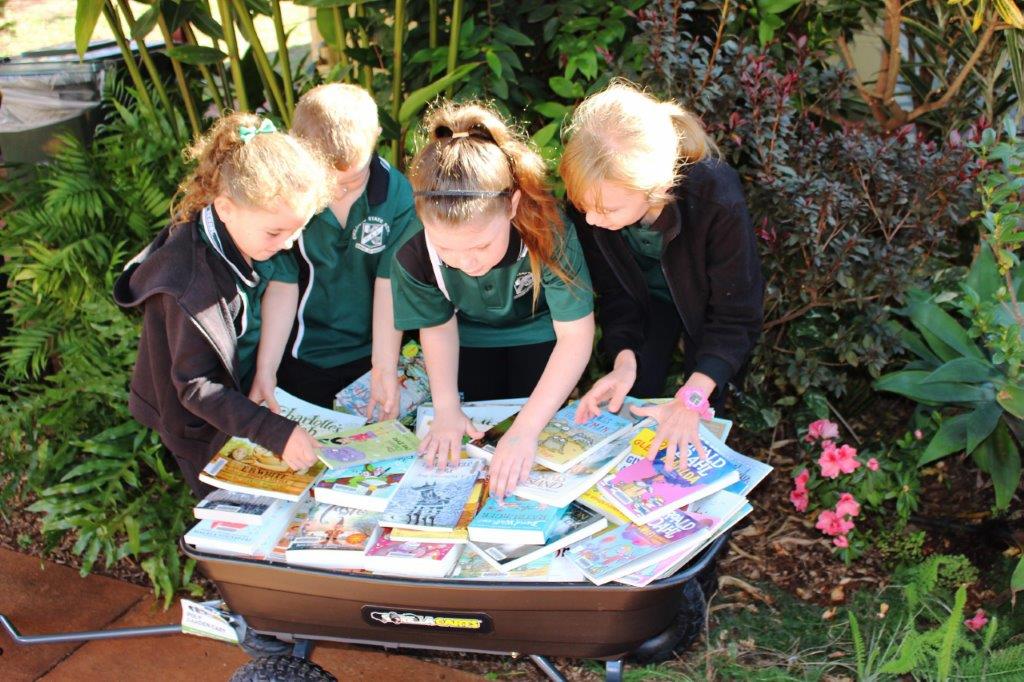 Students enjoy a look at the new books donated to Childers State School by Ergon and Dymocks