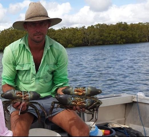 Darcy Lutz with a few mudcrabs he caught recently