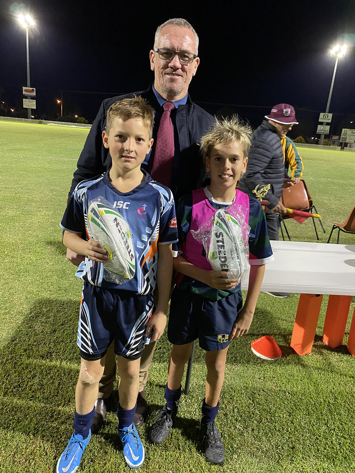 Bundaberg Primary Schools Rugby league Under-12a Players of the Grand Final Cooper Camac (St Mary’s/St Joseph’s) and Drew Woods (St Luke’s) with Bundaberg Primary Schools Rugby League’s Geoff Fitzgerald