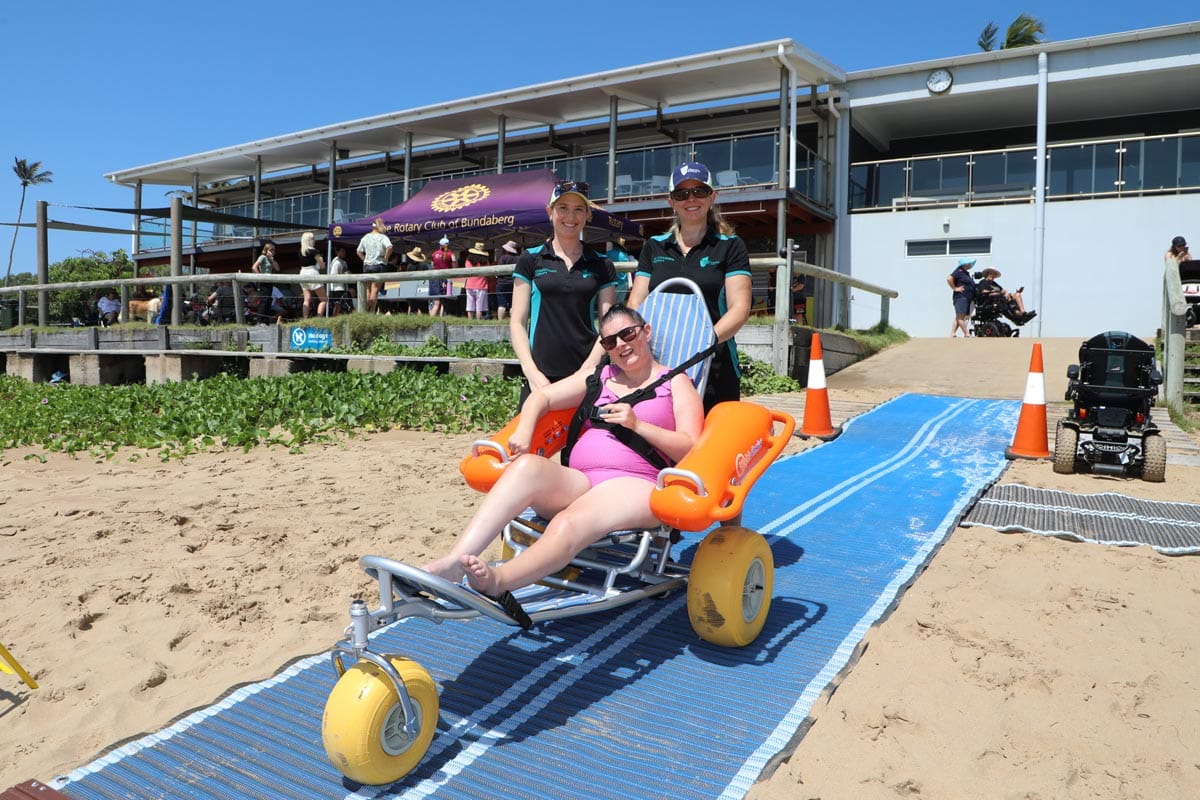 CQU Occupational Therapy students assisting in beach activities.
