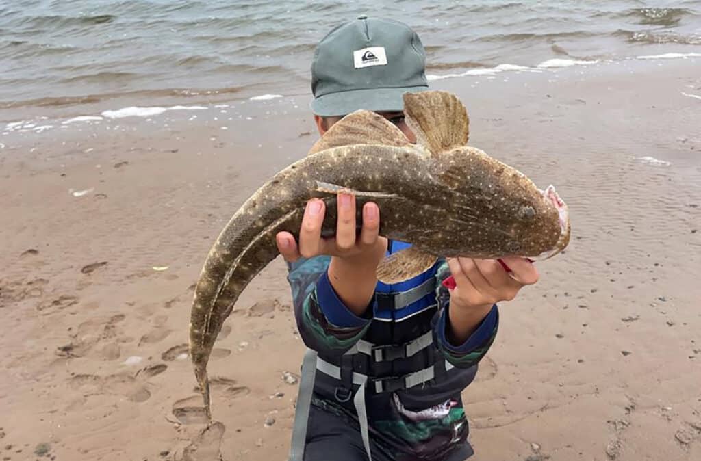 Darcy Reeves with a solid flathead caught in the Burnett