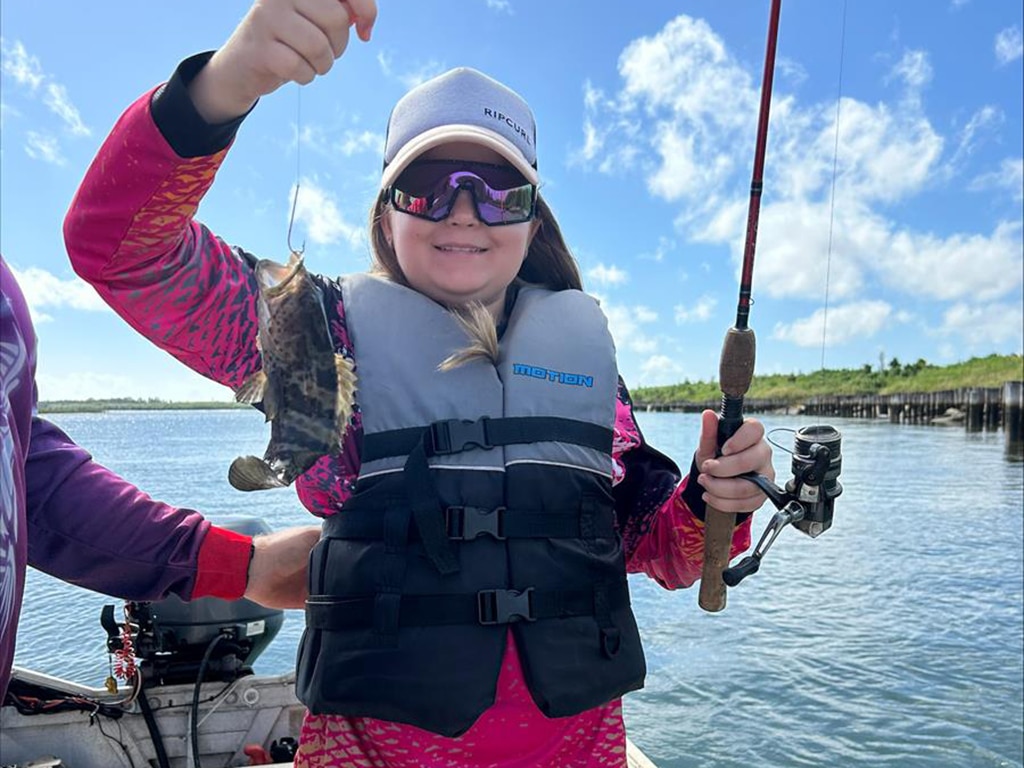 Lilly Myles with an estuary cod she caught.