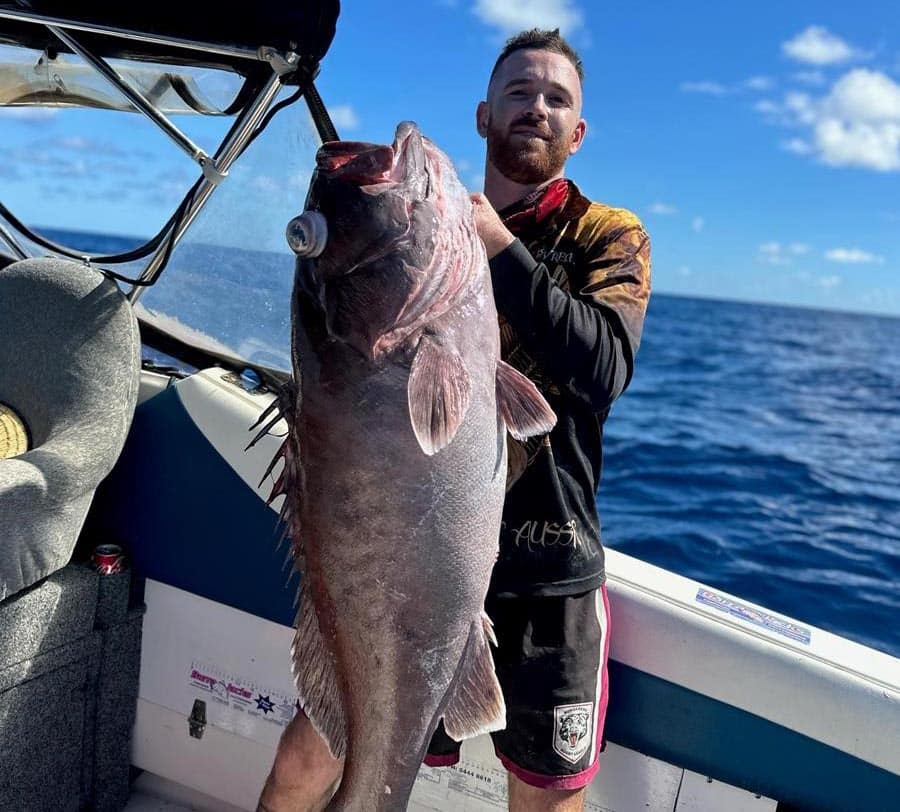 Dylan Taylor with a big bar cod caught on his first deep drop mission